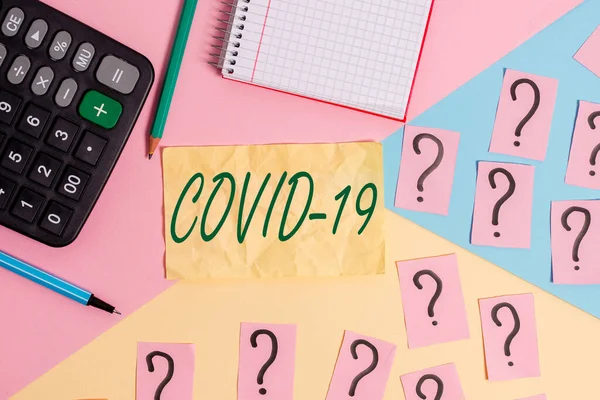 Writing note showing Covid19. Business photo showcasing mild to severe respiratory illness that is caused by a coronavirus Mathematics stuff and writing equipment above pastel colours background. — Stock Photo, Image