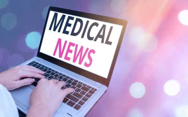 Conceptual hand writing showing Medical News. Business photo showcasing report or noteworthy information on a medical breakthrough Modern gadgets white screen under colorful bokeh background.