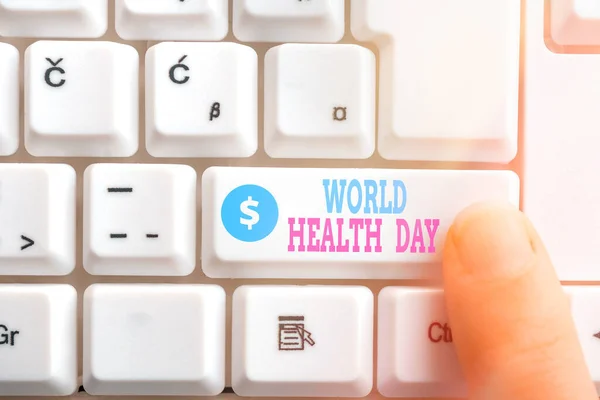Nota escrita que muestra el Día Mundial de la Salud. Foto de negocios que muestra el día mundial de la conciencia de salud celebrado cada año el 7 de abril tecla de teclado PC con el dedo apuntando por encima del espacio de copia de fondo . —  Fotos de Stock