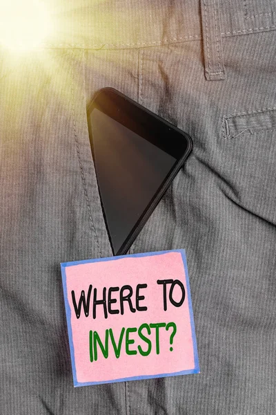 Conceptual hand writing showing Where To Invest Question. Business photo showcasing fundraising money to start business project startup Smartphone device inside trousers front pocket note paper. — Stock Photo, Image