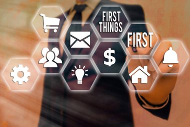 Conceptual hand writing showing First Things First. Business photo text Business, technology, internet, set your priorities and most important Grids and different icons latest digital technology clipart
