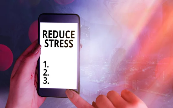 Handwriting text Reduce Stress. Concept meaning to lessen the state of mental or emotional strain or tension Modern gadgets with white display screen under colorful bokeh background.