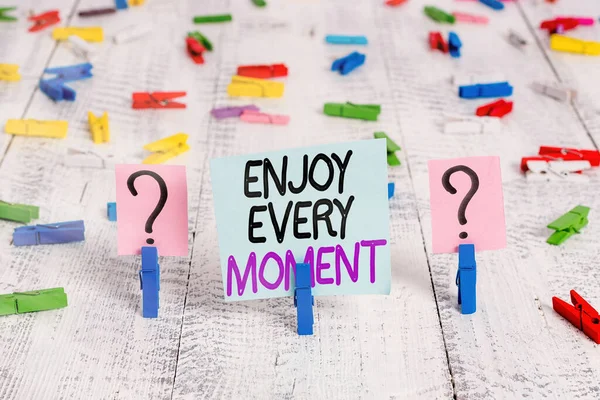 Text sign showing Enjoy Every Moment. Conceptual photo stay positive thinking for an individualal development Scribbled and crumbling sheet with paper clips placed on the wooden table. — Stock Photo, Image