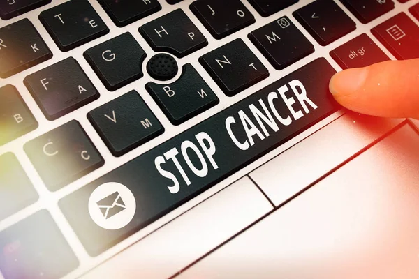 Conceptual hand writing showing Stop Cancer. Business photo text prevent the uncontrolled growth of abnormal cells in the body Pc keyboard key with pointing finger above background copy space. — Stock Photo, Image