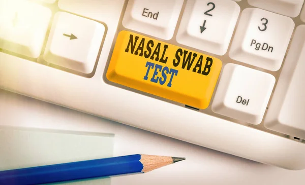 Handwriting text Nasal Swab Test. Concept meaning diagnosing an upper respiratory tract infection through nasal secretion White pc keyboard with empty note paper above white key copy space.