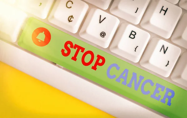 Conceptual hand writing showing Stop Cancer. Business photo showcasing prevent the uncontrolled growth of abnormal cells in the body Colored keyboard key with accessories arranged on copy space. — Stock Photo, Image