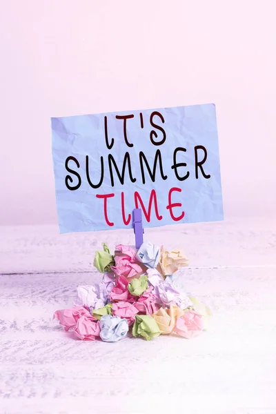 Conceptual hand writing showing It S Summer Time. Business photo showcasing season for fun and excitement enjoying the sunny weather Reminder pile colored crumpled paper clothespin wooden space. — Stock Photo, Image