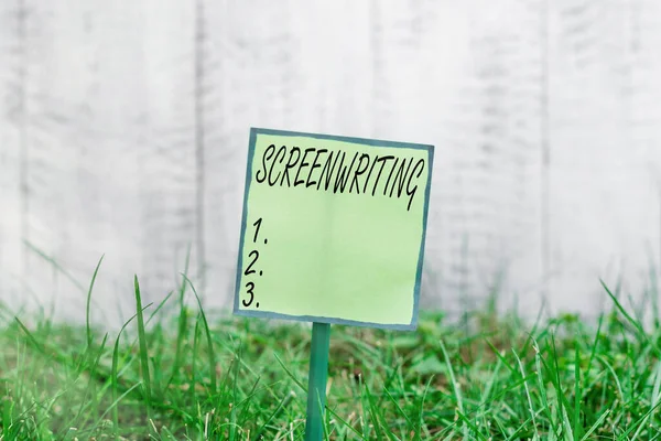 Conceptual hand writing showing Screenwriting. Business photo showcasing the art and craft of writing scripts for media communication Plain paper attached to stick and placed in the grassy land.