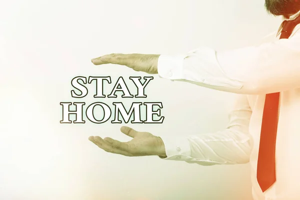 Word writing text Stay Home. Business concept for not go out for an activity and stay inside the house or home Model with pointing hand finger symbolizing navigation progress growth.