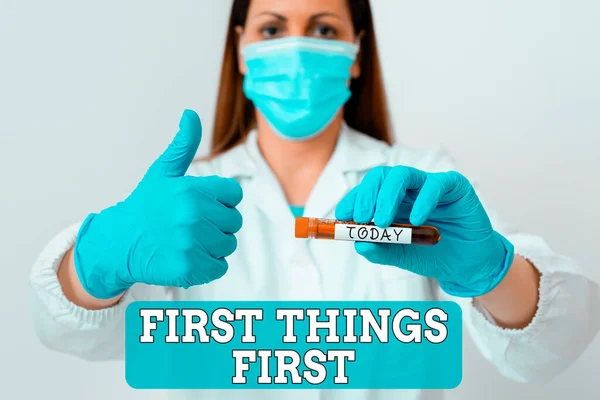 Writing note showing First Things First. Business photo showcasing Business, technology, internet, set your priorities and most important Laboratory blood test sample for medical diagnostic analysis.