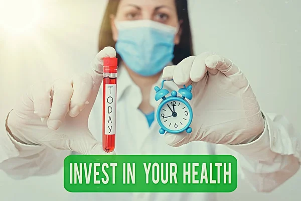 Text sign showing Invest In Your Health. Conceptual photo put money on maintenance or improvement of your health Laboratory blood test sample shown for medical diagnostic analysis result.