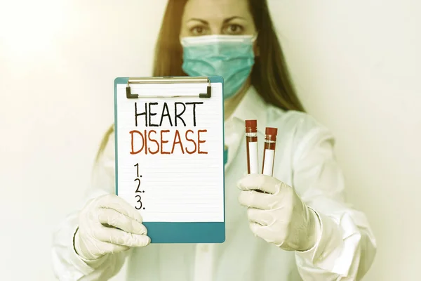 Text sign showing Heart Disease. Conceptual photo A type of disease that affects the heart or blood vessels Laboratory blood test sample shown for medical diagnostic analysis result.