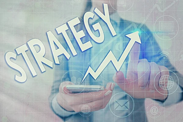 Writing note showing Strategy. Business photo showcasing action plan or strategy designed to achieve an overall goal Arrow symbol going upward showing significant achievement. — Stock Photo, Image