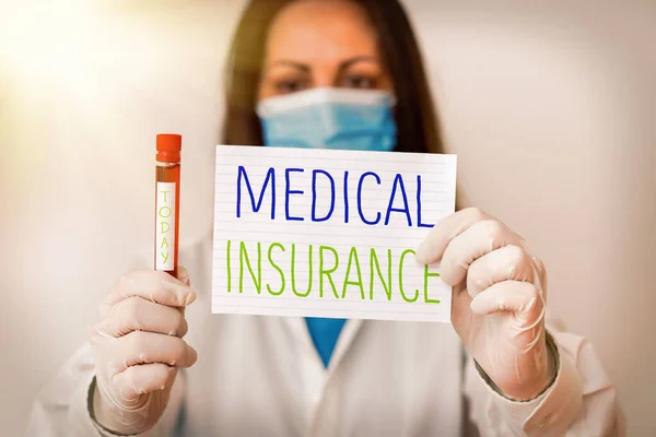 Writing note showing Medical Insurance. Business photo showcasing system of financing the medical expenses of the insured Laboratory blood test sample for medical diagnostic analysis.