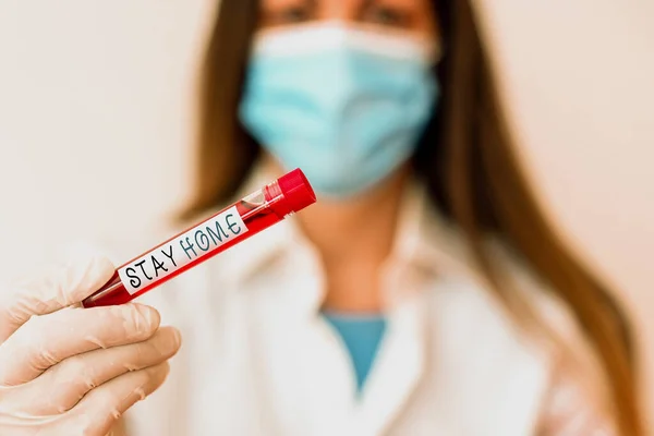 Conceptual hand writing showing Stay Home. Business photo text not go out for an activity and stay inside the house or home Laboratory blood test sample for medical diagnostic analysis.