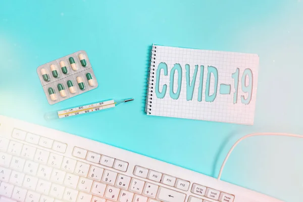 Conceptual hand writing showing Covid19. Business photo showcasing mild to severe respiratory illness that is caused by a coronavirus Set of medical equipment with notepad for health assessment. — Stock Photo, Image