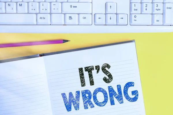Word writing text Its Wrong. Business concept for the reaction of the wrong, unjust, improper or offending action Copy space on notebook above yellow background with keyboard on table.