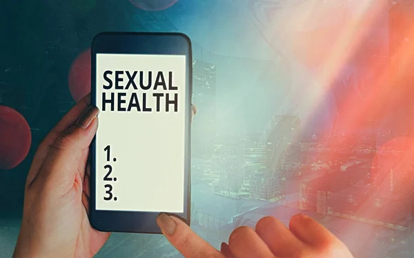 Kézírás szöveg Szexuális egészség. Koncepció jelentése Képesség befogadni és élvezni a szexualitás egész életünkben Modern kütyü fehér kijelző képernyő alatt színes bokeh háttér. — Stock Fotó