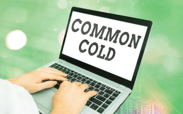 Word writing text Common Cold. Business concept for viral infection in upper respiratory tract primarily affecting nose Modern gadgets with white display screen under colorful bokeh background.