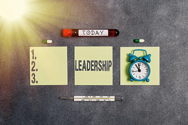 Writing note showing Leadership. Business photo showcasing art of motivating to act toward achieving a common goal Blood sample vial medical accessories ready for examination.