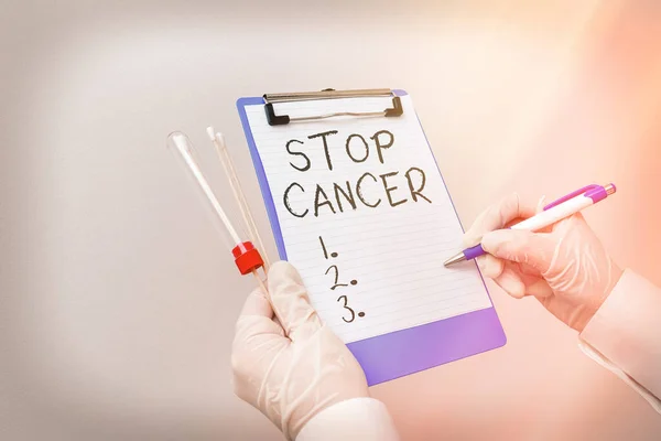 Handwriting text Stop Cancer. Concept meaning prevent the uncontrolled growth of abnormal cells in the body Laboratory blood test sample shown for medical diagnostic analysis result.