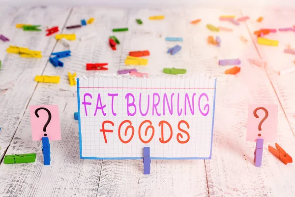 Conceptual hand writing showing Fat Burning Foods. Business photo showcasing produce fat loss by stimulating metabolism to reduce appetite Crumbling sheet with paper clips placed on the wooden table. — Stock Photo, Image