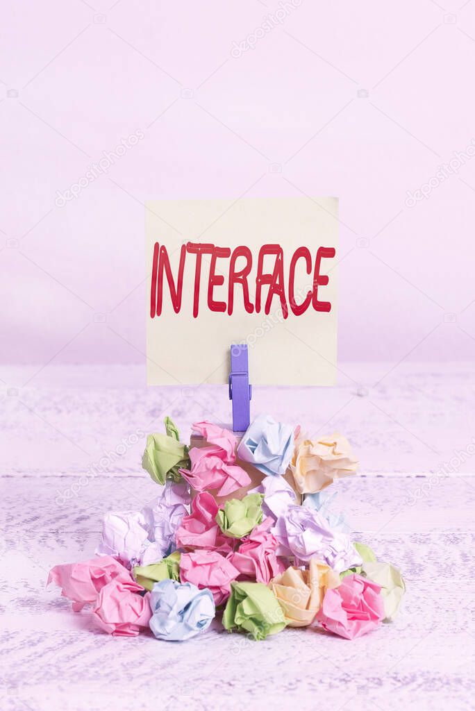 Word writing text Interface. Business concept for point of meeting and communicating between two structures Reminder pile colored crumpled paper clothespin reminder white wooden space.