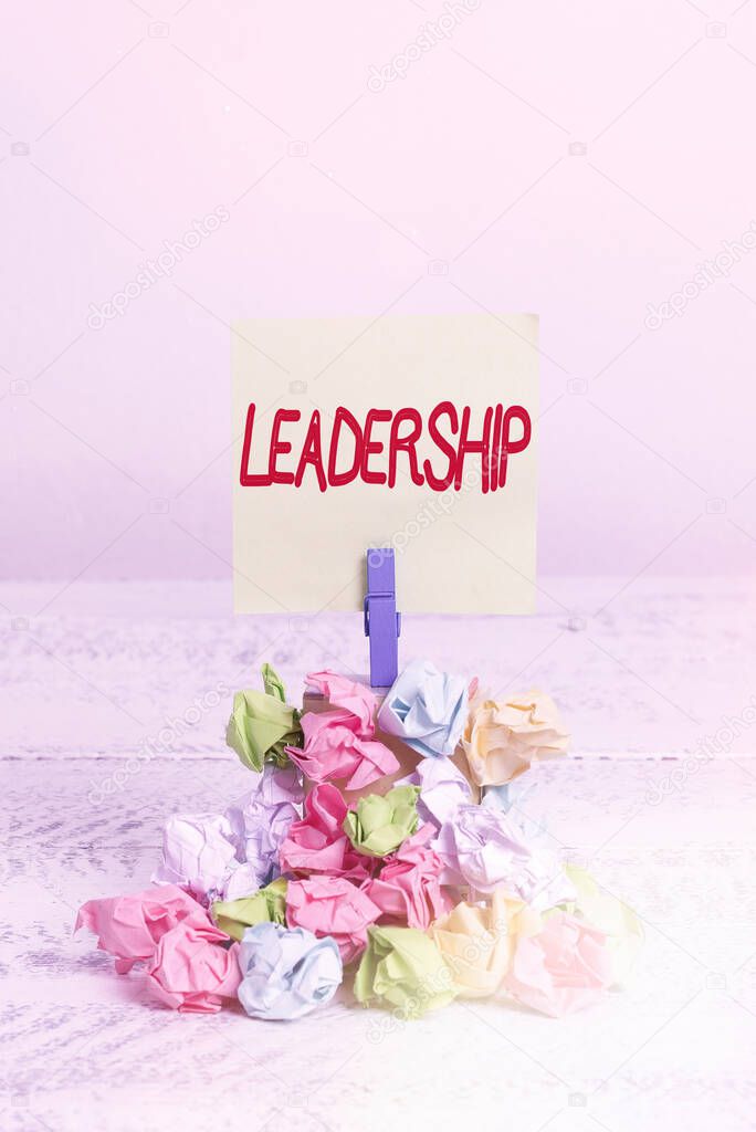 Word writing text Leadership. Business concept for art of motivating to act toward achieving a common goal Reminder pile colored crumpled paper clothespin reminder white wooden space.