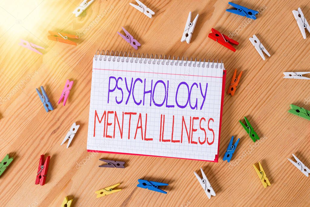 Conceptual hand writing showing Psychology Mental Illness. Business photo text a behavioral pattern that causes significant distress Colored crumpled papers wooden floor background clothespin.