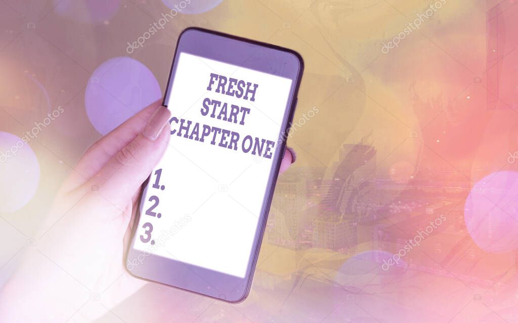 Handwriting text Fresh Start Chapter One. Concept meaning changes in your circumstances new career and chances Modern gadgets with white display screen under colorful bokeh background.