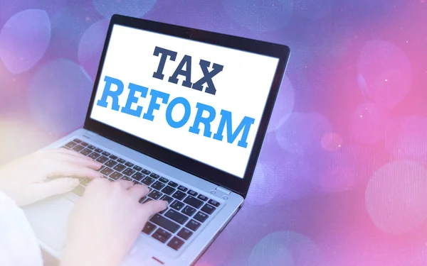 Writing note showing Tax Reform. Business photo showcasing government policy about the collection of taxes with business owners Modern gadgets white screen under colorful bokeh background.