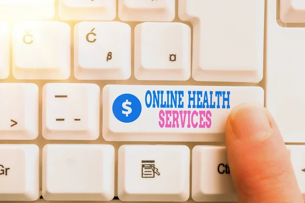 Writing note showing Online Health Services. Business photo showcasing healthcare delivered and enhanced through the internet Pc keyboard key with pointing finger above background copy space. — Stock Photo, Image