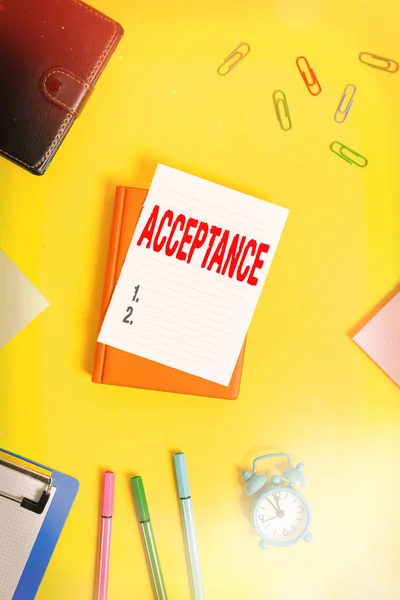 Conceptual hand writing showing Acceptance. Business photo showcasing when you agree to take something officially or act of taking it Pile of empty papers with copy space on the table.