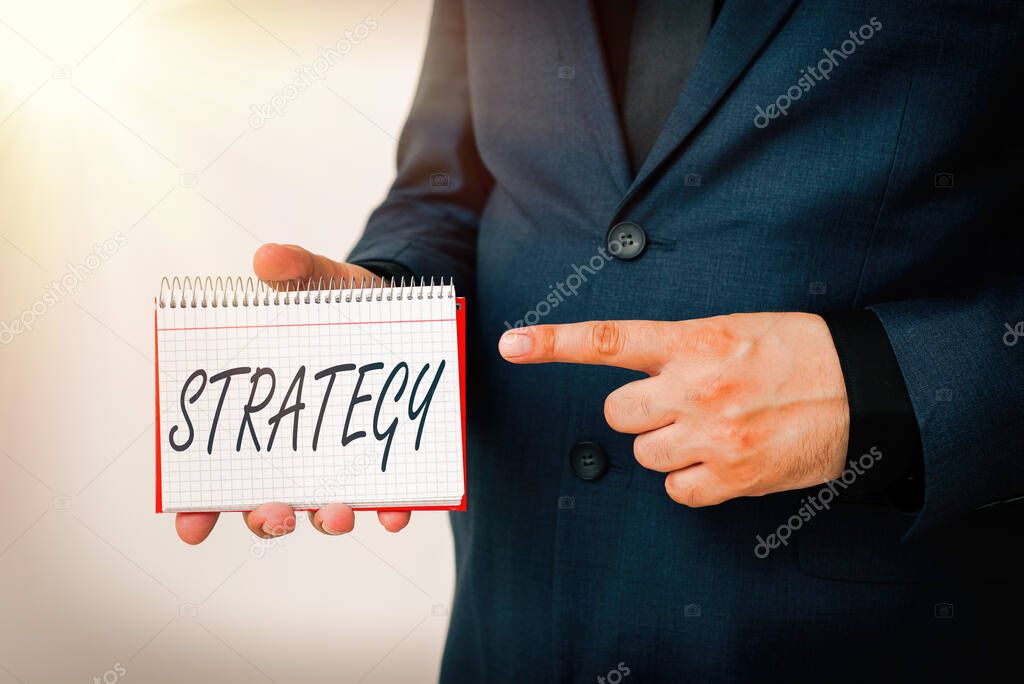 Handwriting text Strategy. Concept meaning action plan or strategy designed to achieve an overall goal Model displaying different empty color notepad mock-up for writing idea.