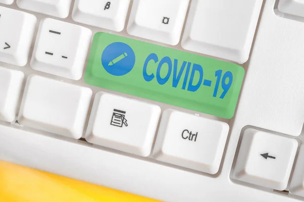 Text sign showing Covid19. Conceptual photo mild to severe respiratory illness that is caused by a coronavirus Different colored keyboard key with accessories arranged on empty copy space. — Stock Photo, Image
