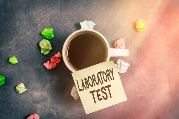 Writing note showing Laboratory Test. Business photo showcasing Determination of a medical diagnosis from the substances tested Paper accessories with smartphone arranged on different background.