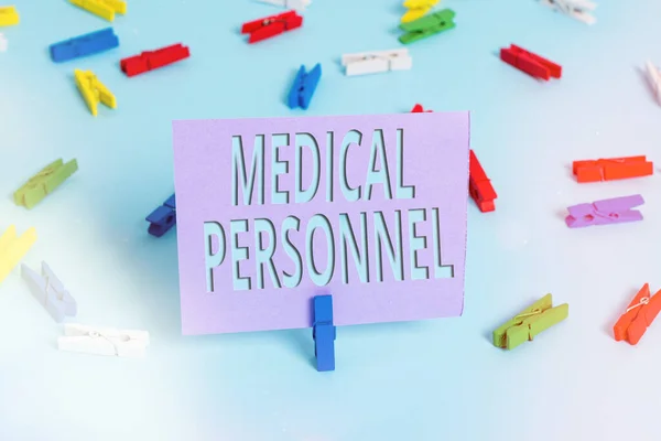 Handwriting text writing Medical Personnel. Concept meaning trusted healthcare service provider allowed to treat illness Colored clothespin papers empty reminder blue floor background office pin.