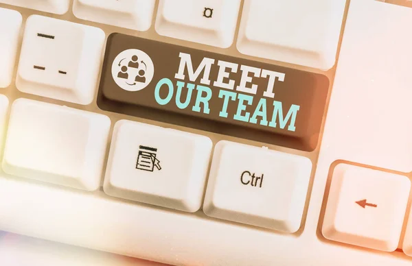 Writing note showing Meet Our Team. Business photo showcasing introducing another an individual to your teammates in the company Colored keyboard key with accessories arranged on empty copy space.