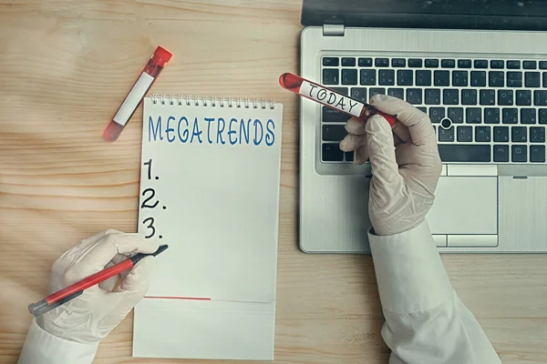 Conceptual hand writing showing Megatrends. Business photo text global patterns related to behavior mobility and environment Blood sample vial lastest technology ready for examination.