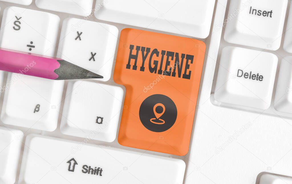 Handwriting text writing Hygiene. Concept meaning study of science of the establishment and maintenance of health Different colored keyboard key with accessories arranged on empty copy space.