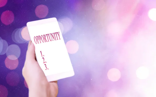 Conceptual hand writing showing Opportunity. Business photo showcasing an opportunity allowing you to do something you want to do Modern gadgets white screen under colorful bokeh background. — Stock Photo, Image