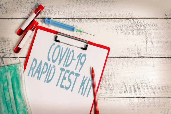 Text sign showing Rapid Test Kit. Conceptual photo Emergency medical diagnostic equipment that deliver fast results Extracted blood sample vial with medical accessories ready for examination. — Stock Photo, Image