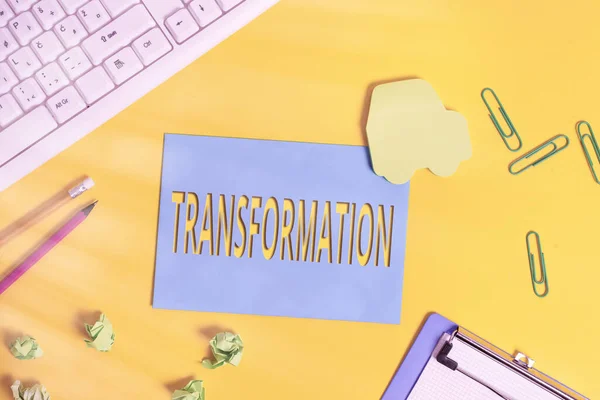 Text sign showing Transformation. Conceptual photo a dramatic or sweeping alteration of shape or appearance Flat lay above empty paper with copy space and colored paper clips.