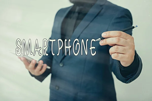 Handwriting text writing Smartphone. Concept meaning a mobile phone that performs many of the computer s is features Model displaying different shots of holding pen ready for promotional use.