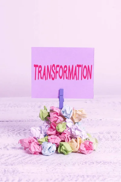 Word writing text Transformation. Business concept for a dramatic or sweeping alteration of shape or appearance Reminder pile colored crumpled paper clothespin reminder white wooden space. — Stock Photo, Image