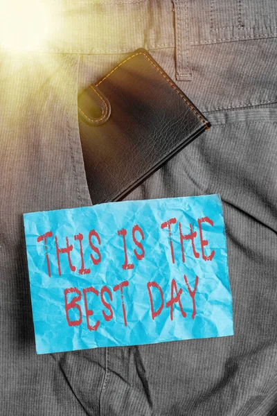 Text sign showing This Is The Best Day. Conceptual photo used to refer to something very good happened today Small little wallet inside man trousers front pocket near notation paper. — Stock Photo, Image