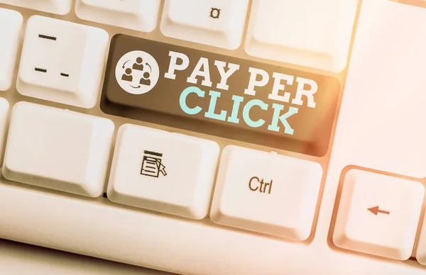 Writing note showing Pay Per Click. Business photo showcasing internet marketing in which payment is based on clickthrough Colored keyboard key with accessories arranged on empty copy space. — Stock Photo, Image