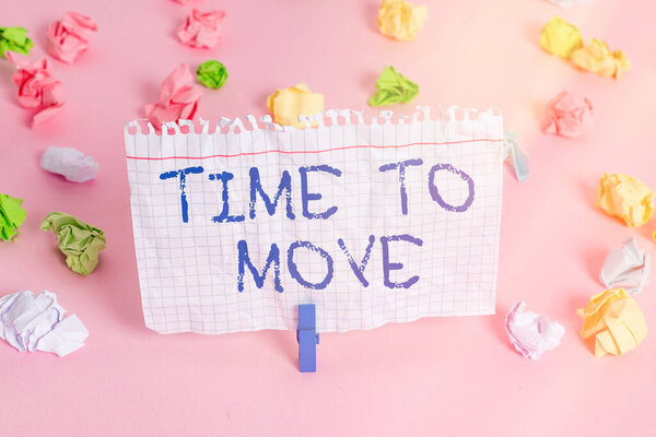 Conceptual hand writing showing Time To Move. Business photo showcasing change in the same way or to reflect on what is current Colored crumpled papers empty reminder pink floor clothespin.
