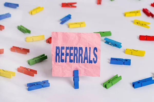 Conceptual hand writing showing Referrals. Business photo text someone or something to research study or take any further action Colored clothespin papers empty reminder white floor office. — Stock Photo, Image