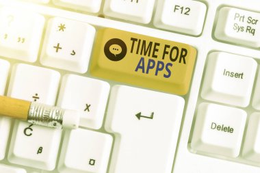 Uygulamalar için Zaman gösteren metin işareti. Kavramsal fotoğraf, uygulamaları ya da servisleri boş kopya alanına yerleştirilmiş aksesuarlarla farklı renklerde klavye anahtarı kullanarak kullanır..